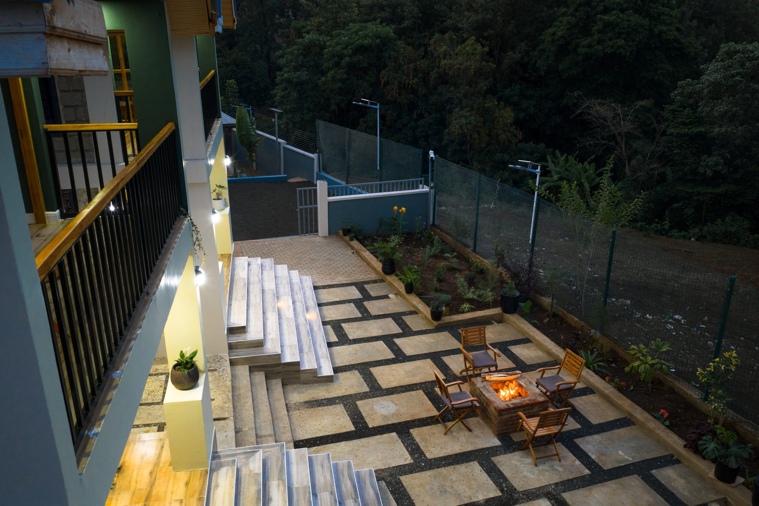 Evening courtyard with fire pit at Starico Residence, a quiet stopover before safari
